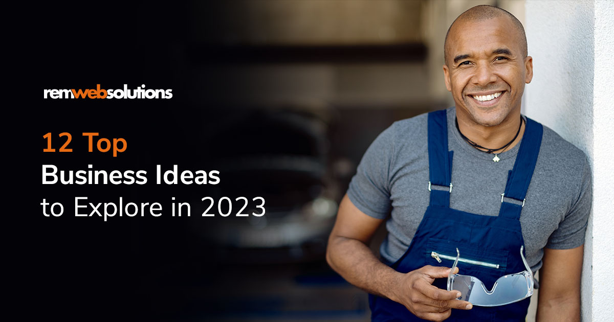 Man working at an auto shop wearing overalls and smiling 